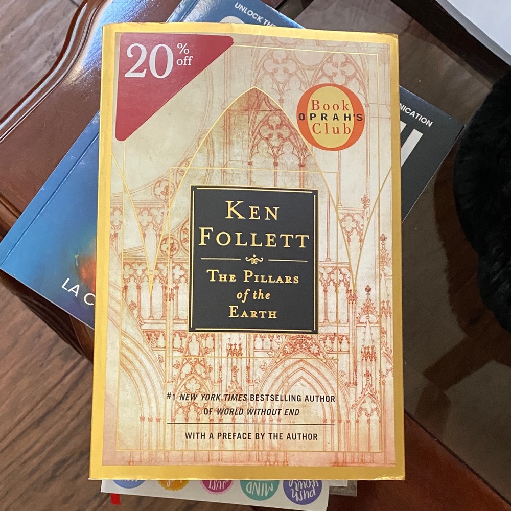 Book 'The Pillars of the Earth' with Red and Gold Accents.